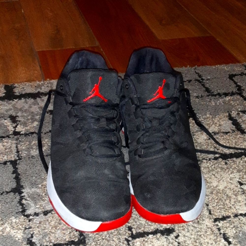 Black and Red Air Jordan's low tops sneakers.